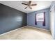 Bedroom features a window, a ceiling fan and light, and neutral walls at 10602 Camelia Dr, Port Richey, FL 34668