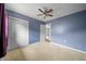 Bedroom features plush carpet, a ceiling fan and double-door closet at 10602 Camelia Dr, Port Richey, FL 34668