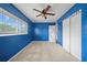 Bedroom features a large window, a double-door closet, and ceiling fan at 10602 Camelia Dr, Port Richey, FL 34668