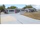 Charming single-story home with a long driveway and cozy front porch at 10602 Camelia Dr, Port Richey, FL 34668