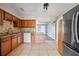 Updated kitchen with stainless steel appliances, granite countertops, tile backsplash and floors at 10602 Camelia Dr, Port Richey, FL 34668