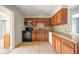 Updated kitchen with stainless steel appliances, granite countertops, and tile flooring at 10602 Camelia Dr, Port Richey, FL 34668