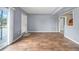 Living room features hardwood flooring, a large front door, and neutral paint at 10602 Camelia Dr, Port Richey, FL 34668