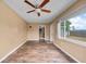 Bright living room with wood floors and natural light from a large window at 10602 Camelia Dr, Port Richey, FL 34668