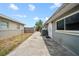 Side yard with gray exterior at 10602 Camelia Dr, Port Richey, FL 34668
