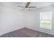 Neutral bedroom with gray carpet and ceiling fan, offering a tranquil retreat at 11257 Linden Depot Rd, San Antonio, FL 33576