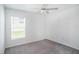 Cozy bedroom features neutral walls, gray carpet and a ceiling fan at 11257 Linden Depot Rd, San Antonio, FL 33576