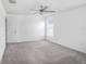 A bedroom with carpeted floors, a ceiling fan, and a window for natural light at 11257 Linden Depot Rd, San Antonio, FL 33576
