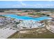 Aerial view of community's large recreational lagoon with sandy beach, lounge chairs, and recreation area at 11257 Linden Depot Rd, San Antonio, FL 33576