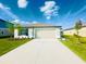 Charming single-story home featuring a two-car garage, well-manicured lawn, and freshly planted landscaping at 11257 Linden Depot Rd, San Antonio, FL 33576