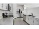 Bright kitchen featuring stainless steel appliances, white cabinets, quartz countertops, and tile floors at 11257 Linden Depot Rd, San Antonio, FL 33576