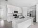 Modern kitchen with stainless steel appliances, white cabinets and large center island at 11257 Linden Depot Rd, San Antonio, FL 33576