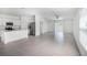Bright living room and kitchen area with stainless appliances and access to the backyard at 11257 Linden Depot Rd, San Antonio, FL 33576