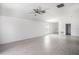 Open-concept living area features a ceiling fan and neutral color palette at 11257 Linden Depot Rd, San Antonio, FL 33576