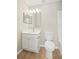 Well-lit bathroom featuring a stylish vanity, toilet, and bathtub with tiled walls at 11323 Ivy Flower Loop, Riverview, FL 33578