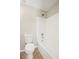 Well-maintained bathroom featuring a toilet, and a tub with a shower and tiled walls at 11323 Ivy Flower Loop, Riverview, FL 33578