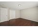 Cozy bedroom features hardwood floors, closet doors, and a neutral color scheme at 11323 Ivy Flower Loop, Riverview, FL 33578