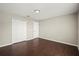 Bedroom with wood-look flooring, neutral paint, and double-door closet at 11323 Ivy Flower Loop, Riverview, FL 33578