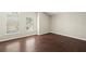 Bedroom featuring wood-look flooring, neutral paint, and natural light from windows at 11323 Ivy Flower Loop, Riverview, FL 33578