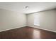 Inviting bedroom showcases hardwood floors, a window, and a neutral color scheme at 11323 Ivy Flower Loop, Riverview, FL 33578