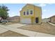 Bright yellow two-story home with a two car garage, black door, and well-maintained lawn at 11323 Ivy Flower Loop, Riverview, FL 33578