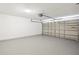 Spacious two car garage with neutral walls and sealed concrete floor at 11323 Ivy Flower Loop, Riverview, FL 33578