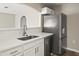 Updated kitchen with stainless steel refrigerator, white cabinets and marble countertops at 11323 Ivy Flower Loop, Riverview, FL 33578