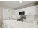 Bright kitchen featuring white cabinets, stainless steel appliances and modern countertop at 11323 Ivy Flower Loop, Riverview, FL 33578