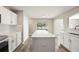 Bright kitchen with stainless steel appliances, white cabinets, modern countertop and island at 11323 Ivy Flower Loop, Riverview, FL 33578