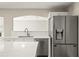 Bright kitchen with stainless steel appliances, white cabinets, and modern countertop at 11323 Ivy Flower Loop, Riverview, FL 33578