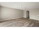 Spacious living room with wood-look flooring and neutral wall paint at 11323 Ivy Flower Loop, Riverview, FL 33578
