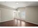 Open-concept living room boasts high ceilings, hardwood floors, and large windows at 11323 Ivy Flower Loop, Riverview, FL 33578