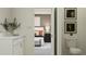 Bright bathroom features a vanity with marble countertops, complemented by a glimpse into the adjacent bedroom at 11745 E 71St Ter, Palmetto, FL 34221