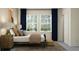 Bright bedroom with two large windows, plush bedding, and an elegant side table at 11745 E 71St Ter, Palmetto, FL 34221