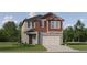 Charming two-story home features a two-car garage and nicely landscaped front yard at 11745 E 71St Ter, Palmetto, FL 34221