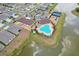 A view of the community pool, clubhouse, playground, parking and tennis courts all next to a pond and neighborhood at 13055 Willow Grove Dr, Riverview, FL 33579