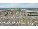 High-angle view of a residential community with a lake and greenery in the distance at 13055 Willow Grove Dr, Riverview, FL 33579