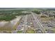 Aerial view of an orderly suburban neighborhood with houses, streets, green spaces, and a small lake at 13055 Willow Grove Dr, Riverview, FL 33579
