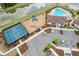 A view of the community tennis courts, playground, parking and pool near a lake with well manicured landscaping at 13055 Willow Grove Dr, Riverview, FL 33579