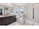 Elegant bathroom features a tub and a glass-enclosed shower, perfect for a luxurious bathing experience at 13055 Willow Grove Dr, Riverview, FL 33579