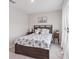 Comfortable bedroom featuring a bed with stylish bedding, side tables, and natural light streaming from the window at 13055 Willow Grove Dr, Riverview, FL 33579