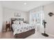 Cozy bedroom featuring a comfortable bed with stylish bedding and bright natural light from the window at 13055 Willow Grove Dr, Riverview, FL 33579