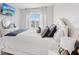 Charming bedroom with decorative pillows, bedside table, and a large window, creating a serene atmosphere at 13055 Willow Grove Dr, Riverview, FL 33579
