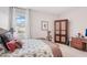 Inviting bedroom with a decorative headboard, stylish decor, and a view of the backyard at 13055 Willow Grove Dr, Riverview, FL 33579