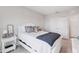 Comfortable bedroom features a white bed frame, soft pillows, and a window for natural light, creating a peaceful retreat at 13055 Willow Grove Dr, Riverview, FL 33579