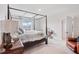 Bright bedroom featuring a four-poster bed, neutral walls, and plush carpeting for a cozy and inviting space at 13055 Willow Grove Dr, Riverview, FL 33579