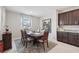 Formal dining room with dark wood table, upholstered chairs, modern decor, and neutral colors at 13055 Willow Grove Dr, Riverview, FL 33579