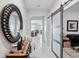 Elegant entryway with tile flooring, decorative mirror, barn door, and neutral paint at 13055 Willow Grove Dr, Riverview, FL 33579