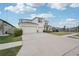 Bright exterior view showcasing a three-car garage, lush lawn and tidy landscaping at 13055 Willow Grove Dr, Riverview, FL 33579