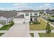Beautiful two-story home with a three-car garage, manicured lawn and stone accents at 13055 Willow Grove Dr, Riverview, FL 33579